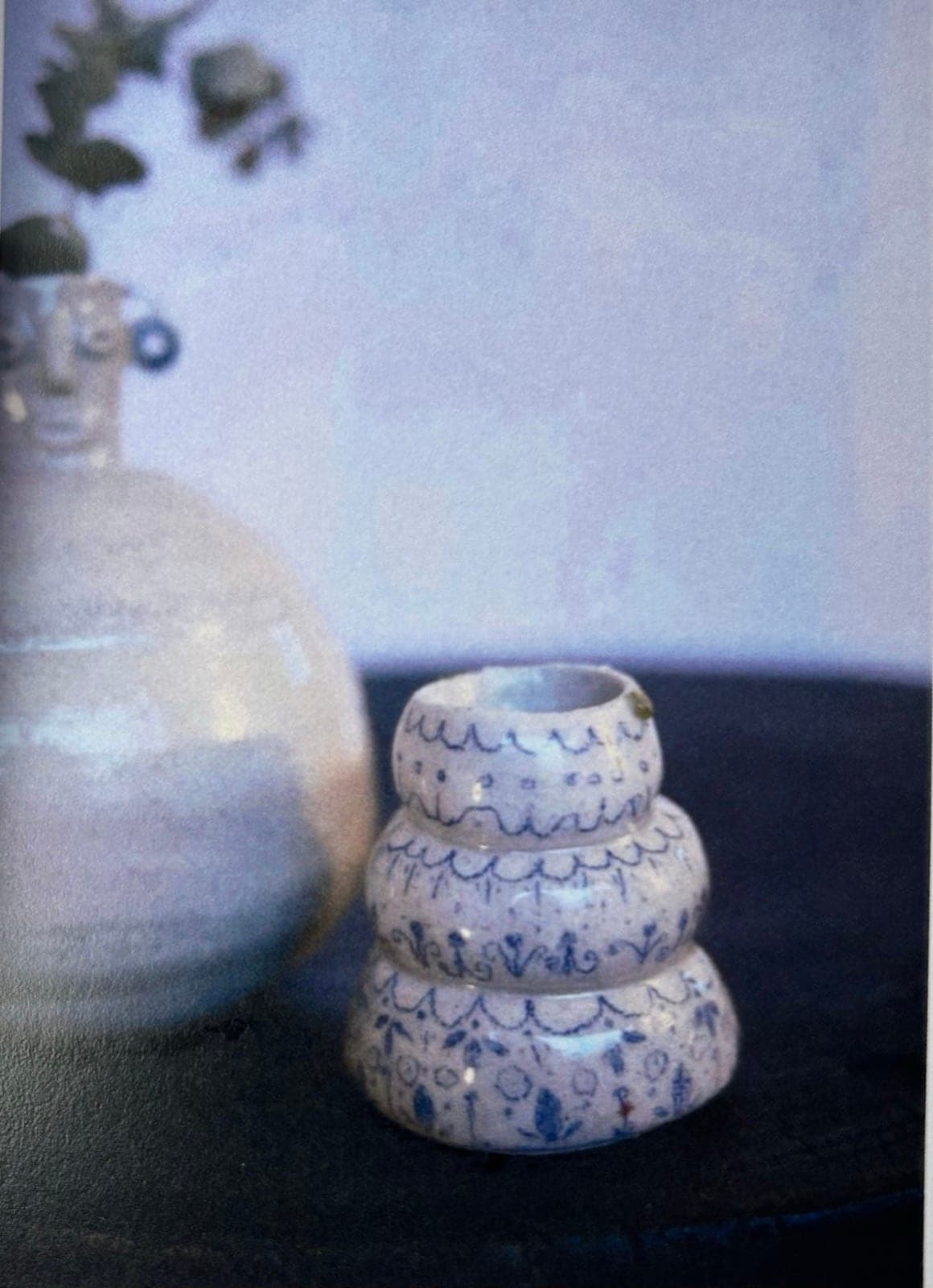 A stacked three-tier vessel painted with blue patterns