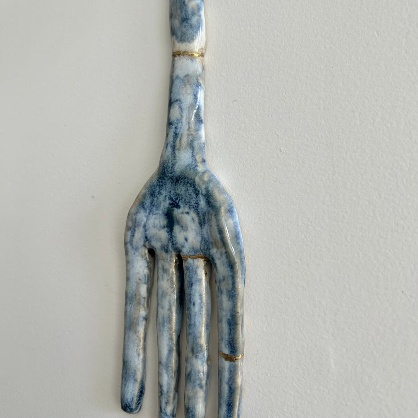 Close-up of the repaired fork, showing gold seams across the handle and tines