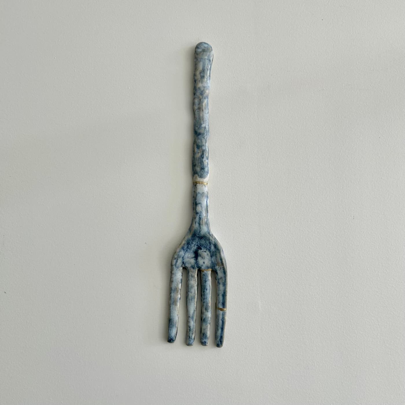 The same fork after repair, whole again with thin gold seams